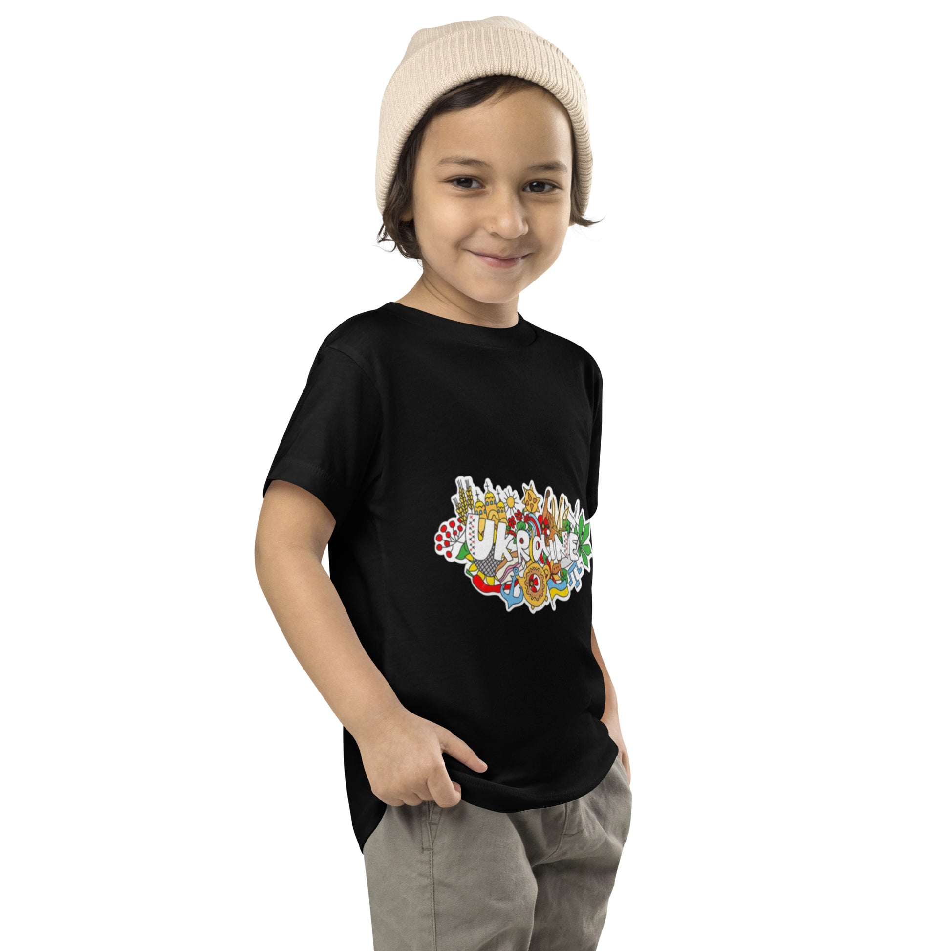 Toddler wearing black short sleeve t-shirt with colorful Ukraine design, showcasing cultural pride and playful style.