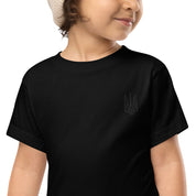 Toddler wearing black short sleeve tee with Ukrainian Tryzub design, made from 100% cotton for comfort and durability.