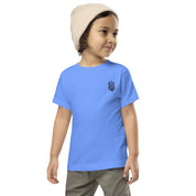 Toddler wearing short sleeve tee with Ukrainian Tryzub print, crafted from soft blue cotton, ideal for active play and comfort.
