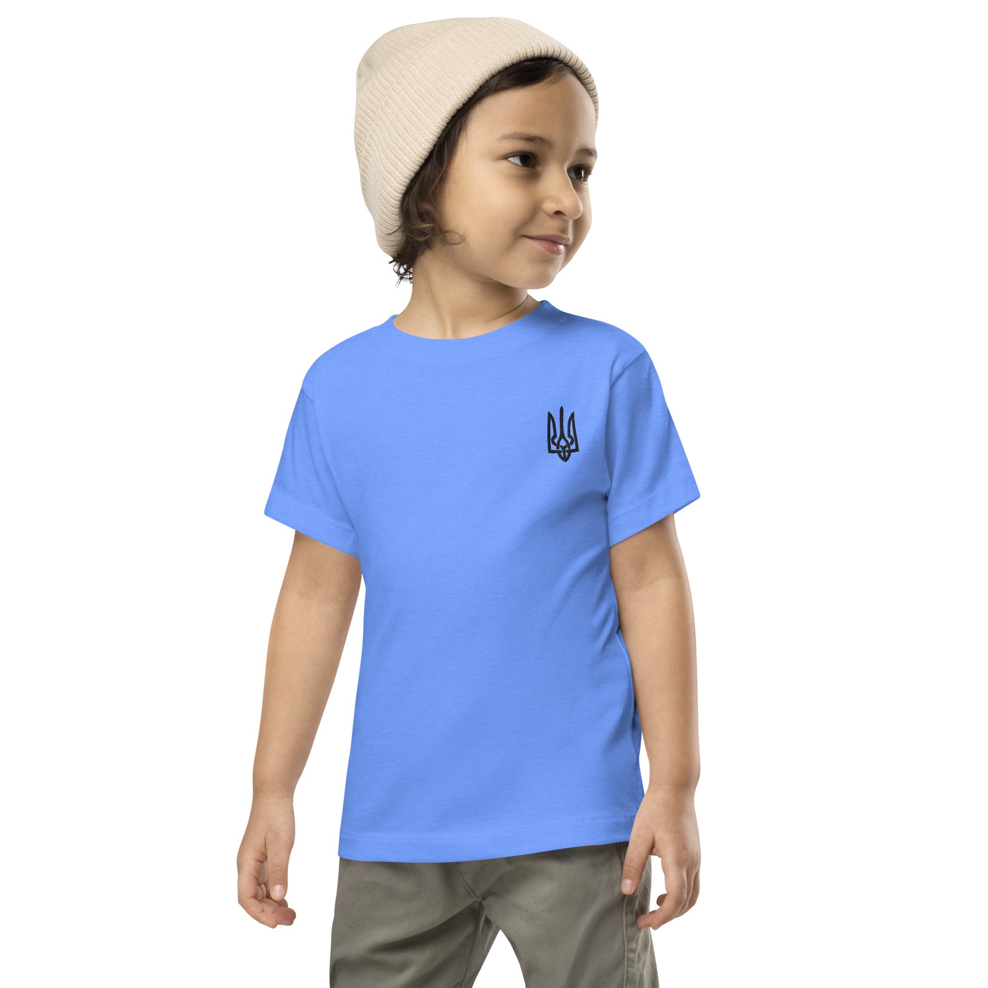 Toddler wearing short sleeve tee with Ukrainian Tryzub print, crafted from soft blue cotton, ideal for active play and comfort.