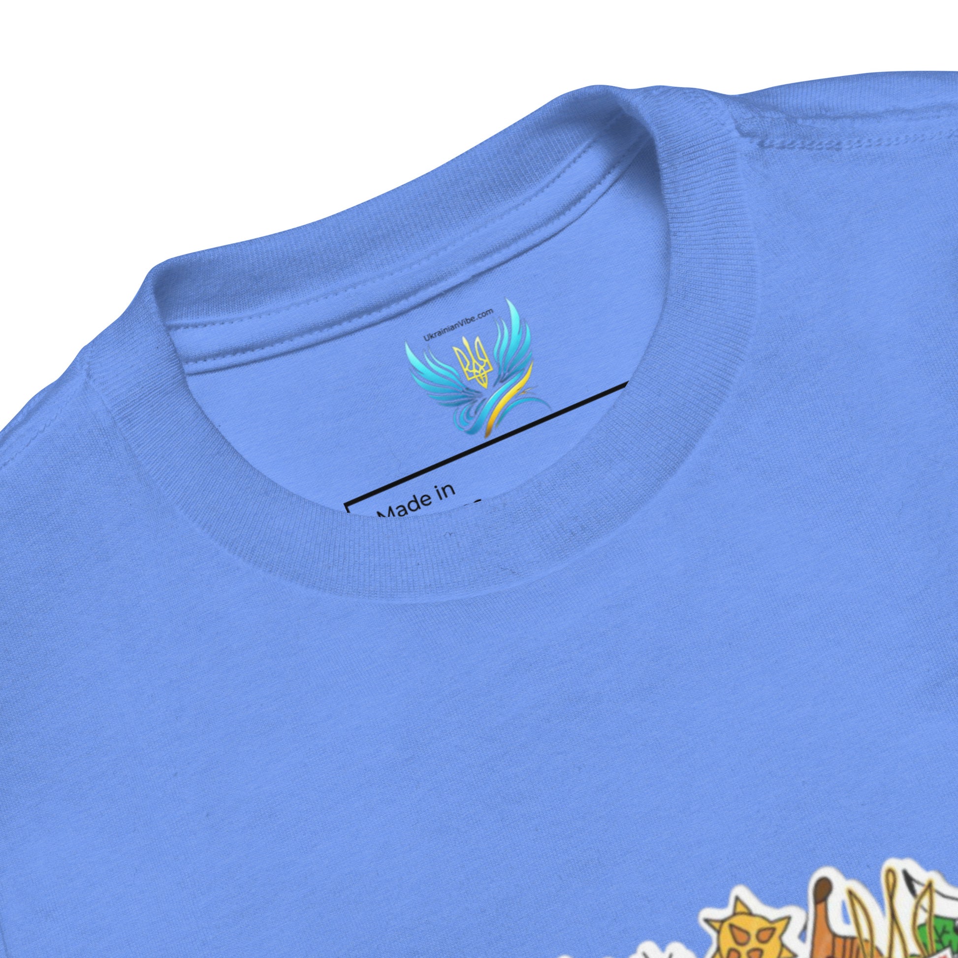 Toddler short sleeve t-shirt with Ukraine design on blue fabric, featuring soft cotton material and cultural print details.