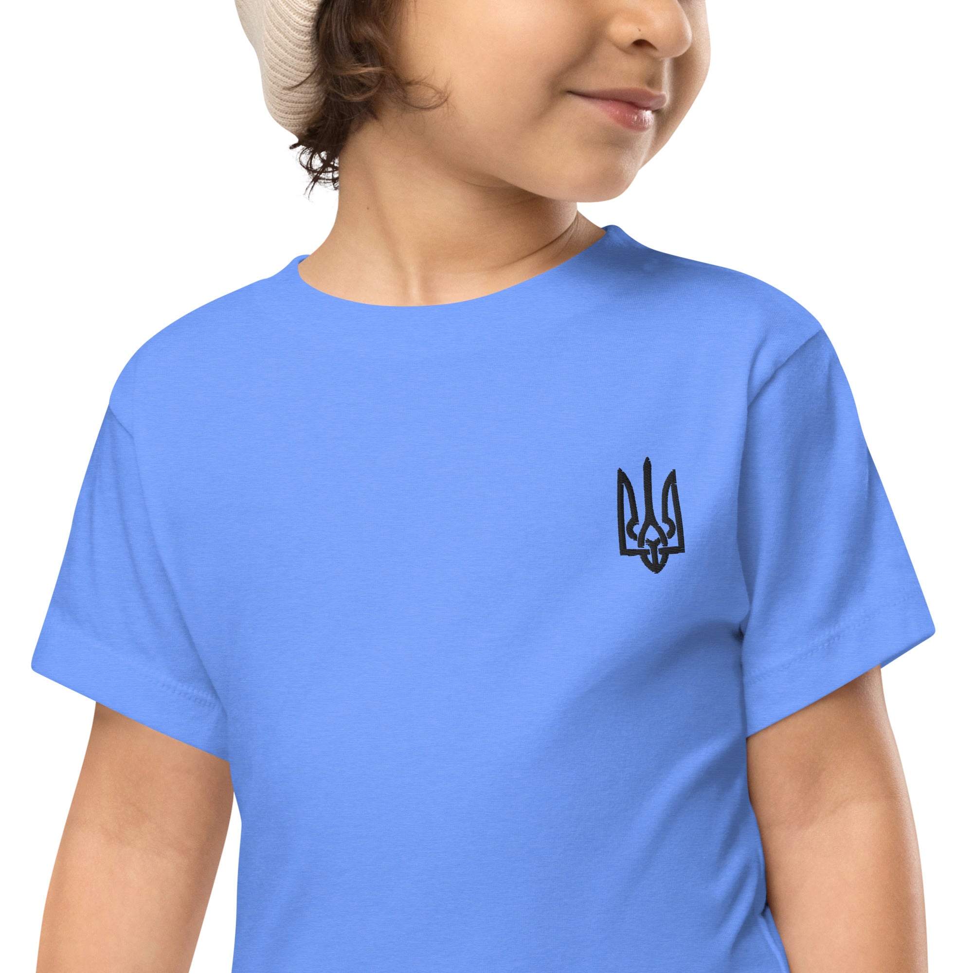 Toddler wearing blue short sleeve tee with Ukrainian Tryzub print, showcasing comfort and style in premium cotton fabric.