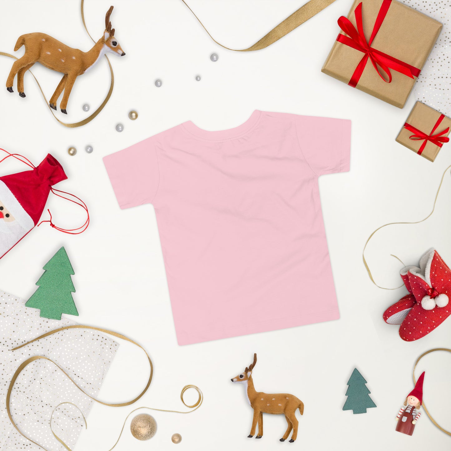 Pink toddler short sleeve T-shirt with Ukraine design amidst festive holiday decorations including reindeer and gift boxes.