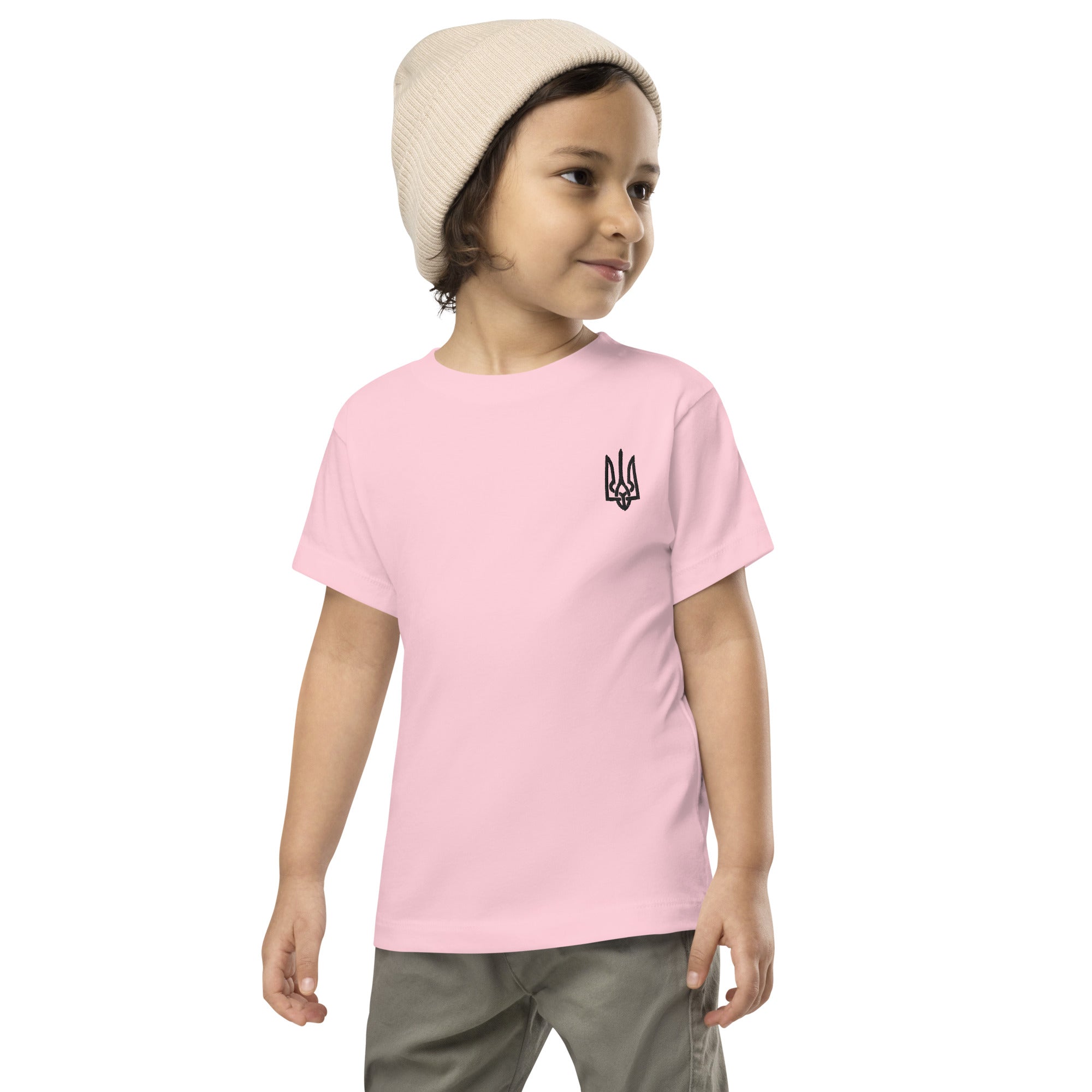 Toddler wearing pink short-sleeve tee with Ukrainian Tryzub print, made from soft cotton for comfort and style.