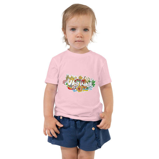 Toddler wearing a pink short sleeve T-shirt with Ukraine-themed design, combining style and comfort for playtime and outings.