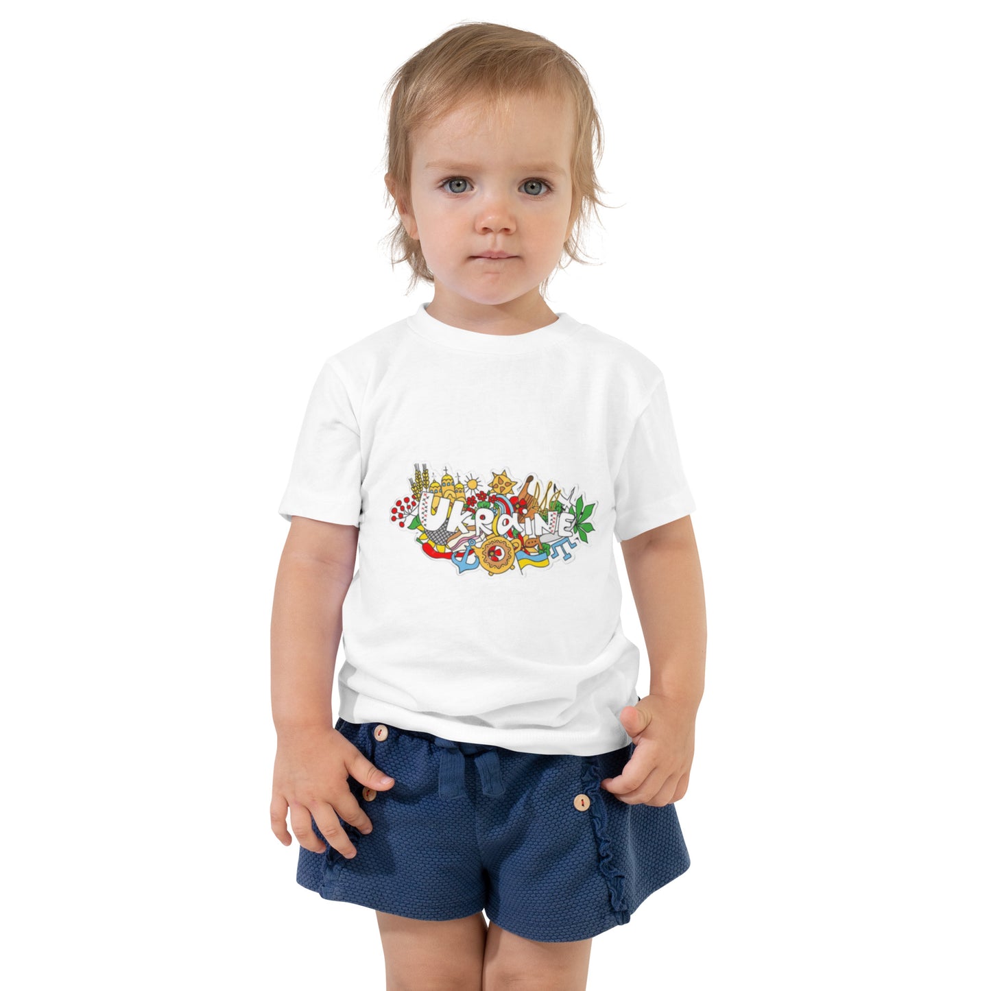 Toddler wearing white short sleeve t-shirt with Ukraine design, showcasing cultural pride and style.