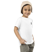 Toddler wearing a white short sleeve tee with Ukrainian Tryzub print, paired with a beige beanie and green pants.
