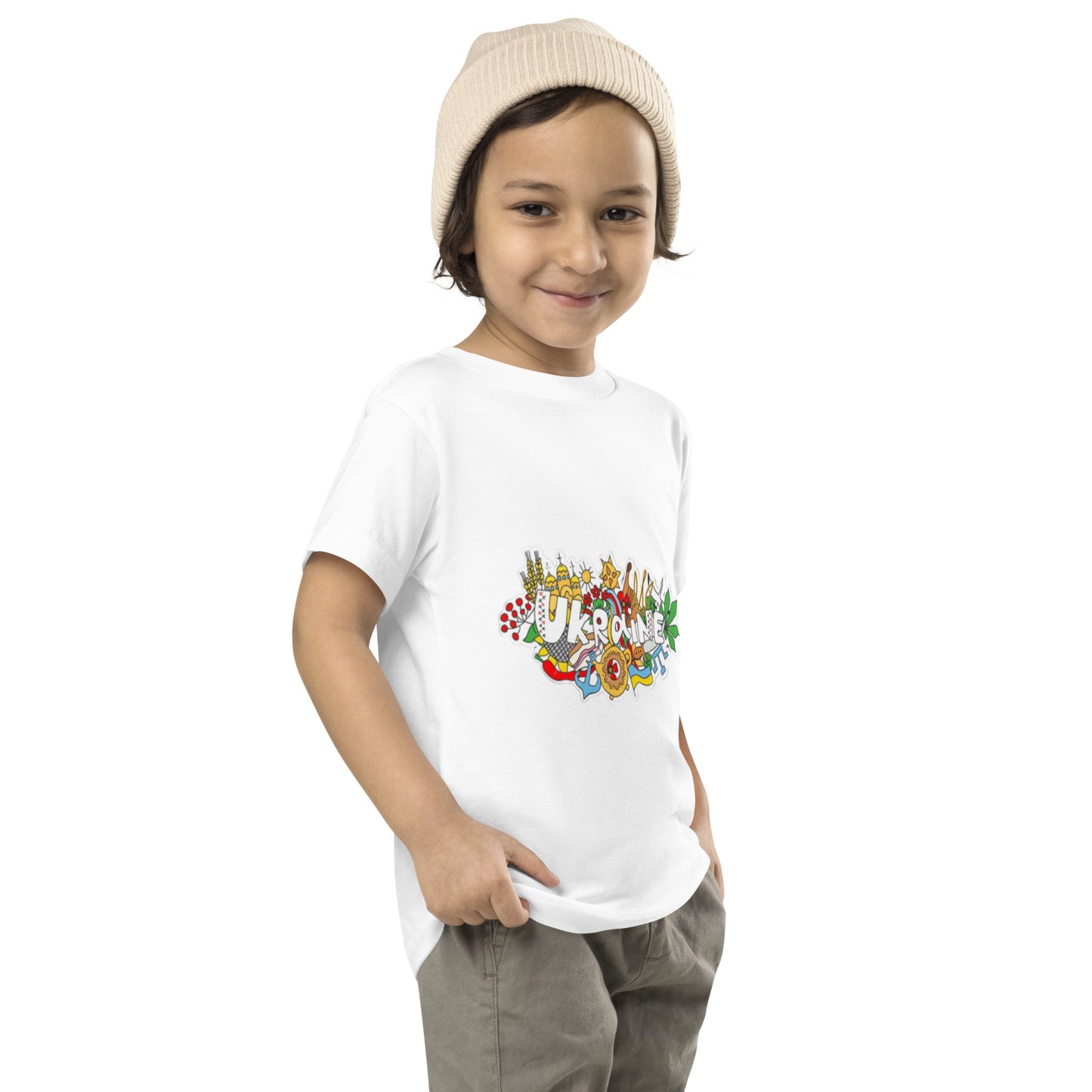 Toddler in Ukraine-themed short sleeve t-shirt, showcasing cultural design, casual outfit, and beanie hat.