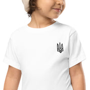 Toddler wearing a white short-sleeve tee with Ukrainian Tryzub print, perfect for comfort and play.