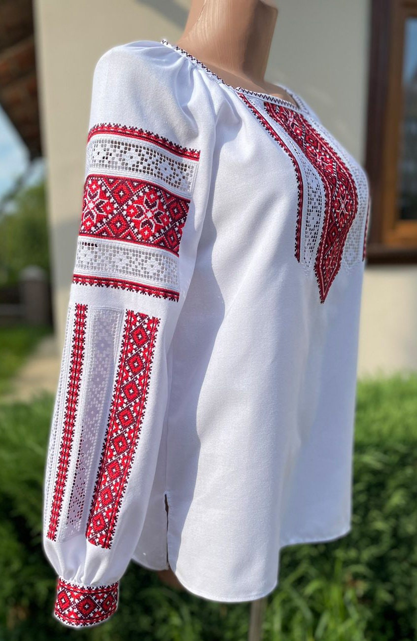 Women's traditional cotton vyshyvanka blouse with red and black Ukrainian folk embroidery, featuring ornate cross-stitch patterns.