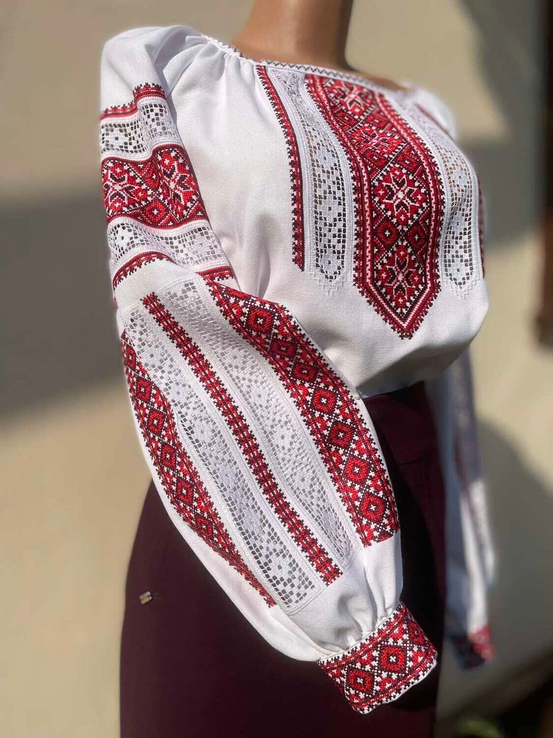 Traditional cotton vyshyvanka blouse with red and black Ukrainian folk embroidery on sleeves and chest.