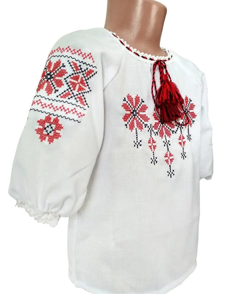 Traditional Ukrainian embroidered blouse for girls with red, black, blue ornament, Rosava design, ages 2–8, perfect for celebrations.