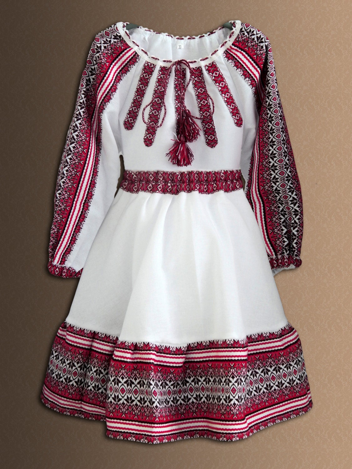 Traditional Ukrainian girl's embroidered blouse and skirt set, folk style, soft cotton blend, red and white Vyshyvanka design.