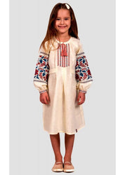 Girl wearing a traditional Ukrainian embroidered linen dress with floral cross-stitch and buttoned straps