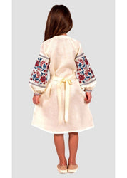 Back view of a girl wearing a traditional Ukrainian embroidered linen dress with floral cross-stitch on sleeves and a waist tie