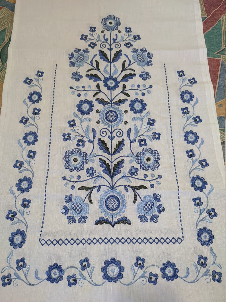Embroidered Tree of Life design on traditional Ukrainian wedding rushnyk made of 100% linen, featuring blue floral motifs.