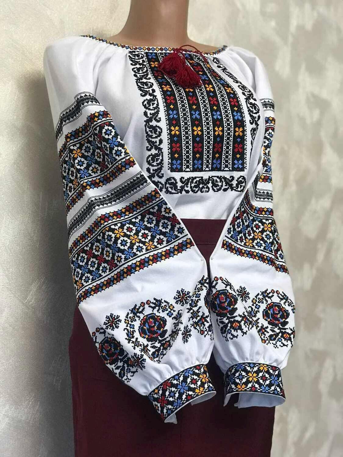 Women's Ukrainian vyshyvanka embroidered blouse with traditional ethnic patterns on homespun fabric, featuring vibrant cross-stitch.