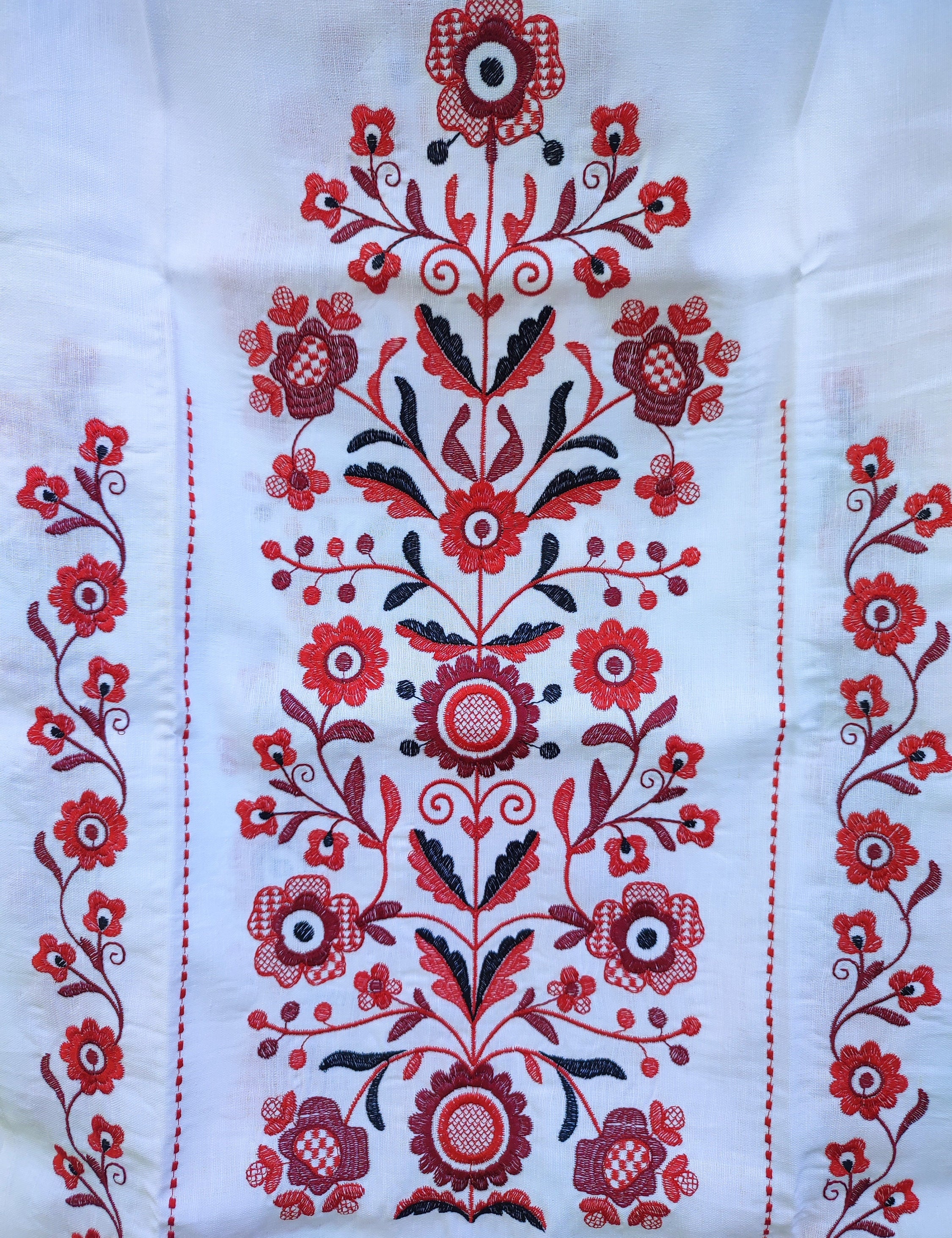 Traditional Ukrainian rushnyk with red Tree of Life embroidery on linen, symbolizing prosperity and protection.