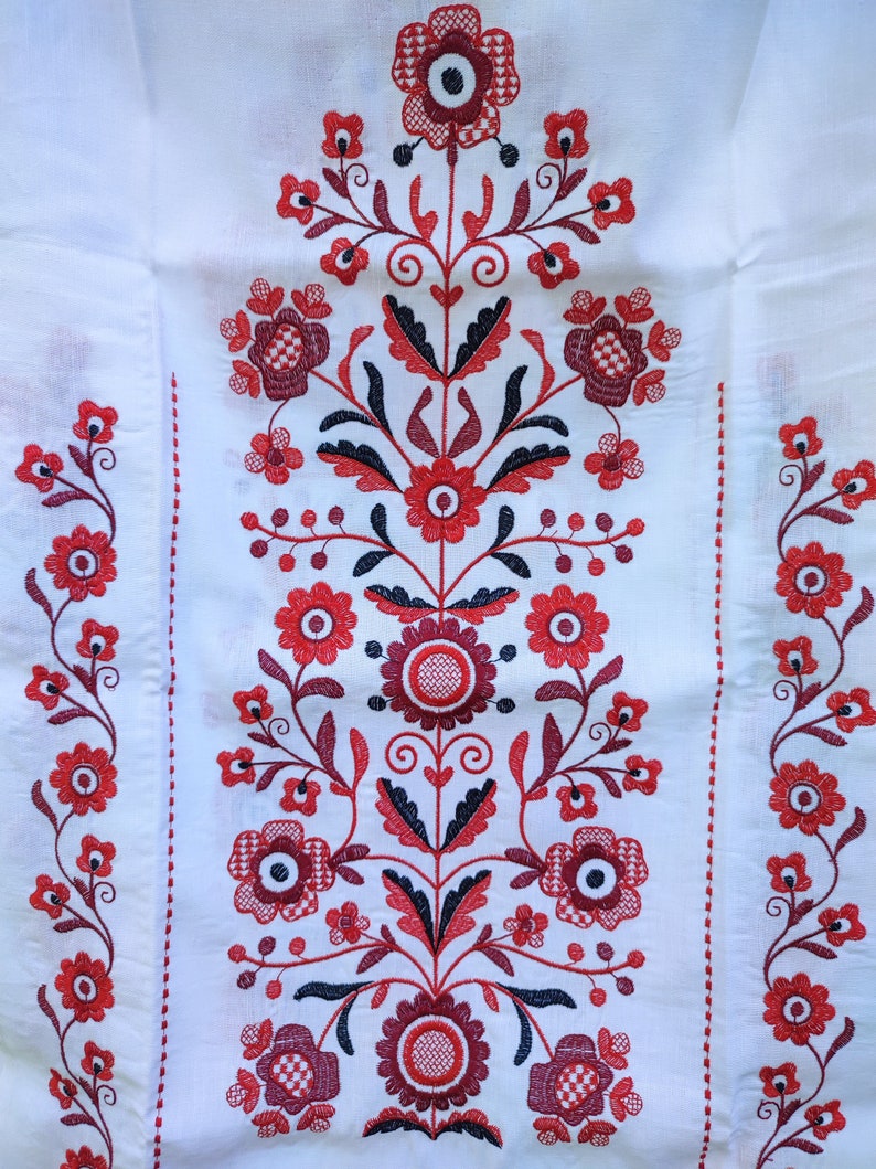 Traditional Ukrainian rushnyk with red Tree of Life embroidery on linen, symbolizing prosperity and protection.