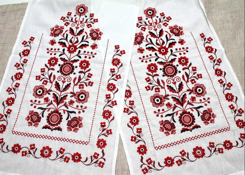Traditional Ukrainian wedding rushnyk with red Tree of Life embroidery on white linen.
