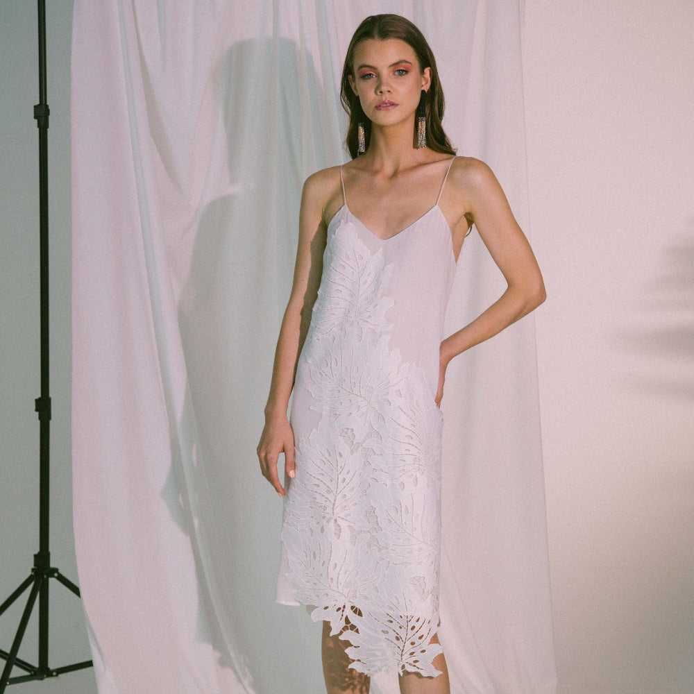 Woman wearing Solea Crinkle Slip Dress with adjustable straps and elegant design, ideal for comfort and minimalistic style.