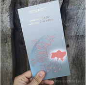 Limited edition Ukraine 50 UAH "Unity Saves the World" commemorative banknote in a souvenir booklet held by hand.