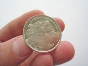 Person holding Ukrainian 10 Hryvnia commemorative coin, 2021, featuring Land Forces of Ukraine design.