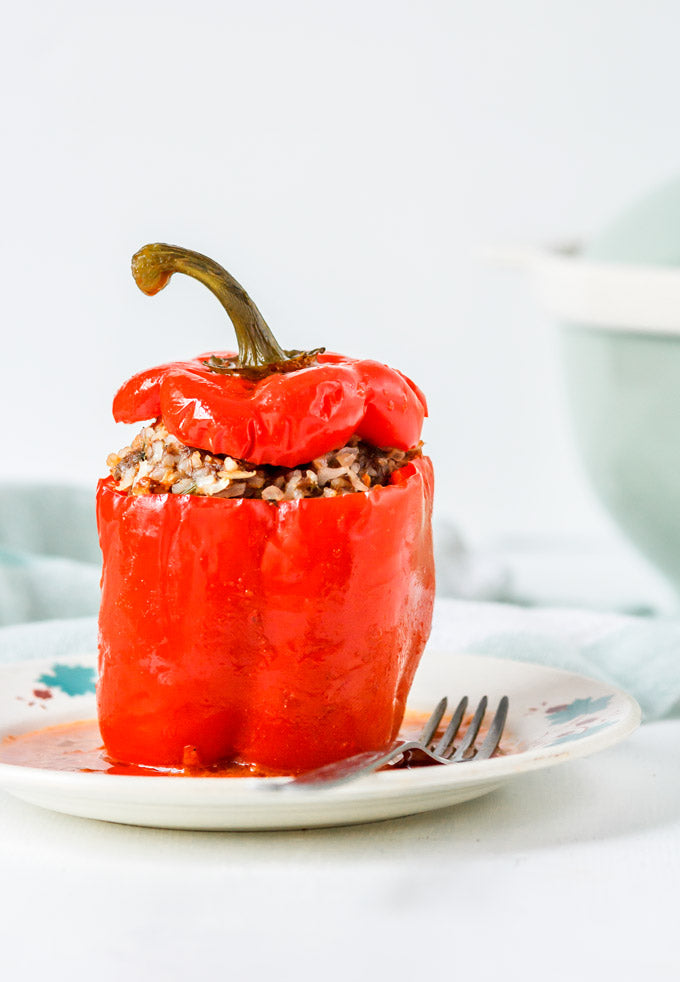 Alt Tag: Homemade Ukrainian stuffed pepper with rice and meat filling on a white plate, showcasing a traditional comfort food dish.