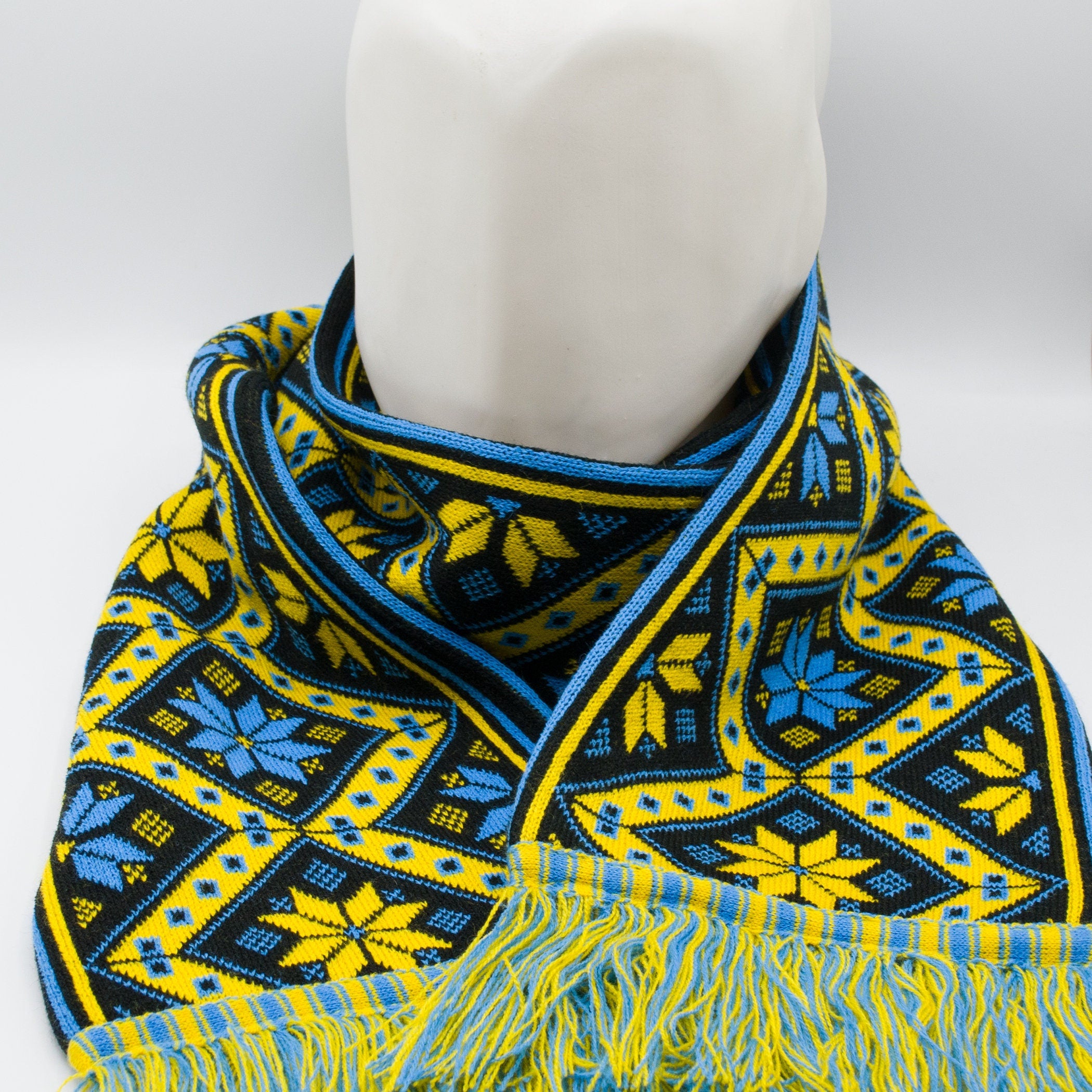 Cozy knit scarf with traditional Ukrainian geometric pattern in yellow and blue, hypoallergenic, perfect for winter warmth.