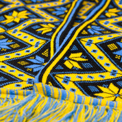 Cozy knit scarf with traditional Ukrainian ornament, featuring a vibrant yellow-blue geometric pattern, perfect for winter warmth.