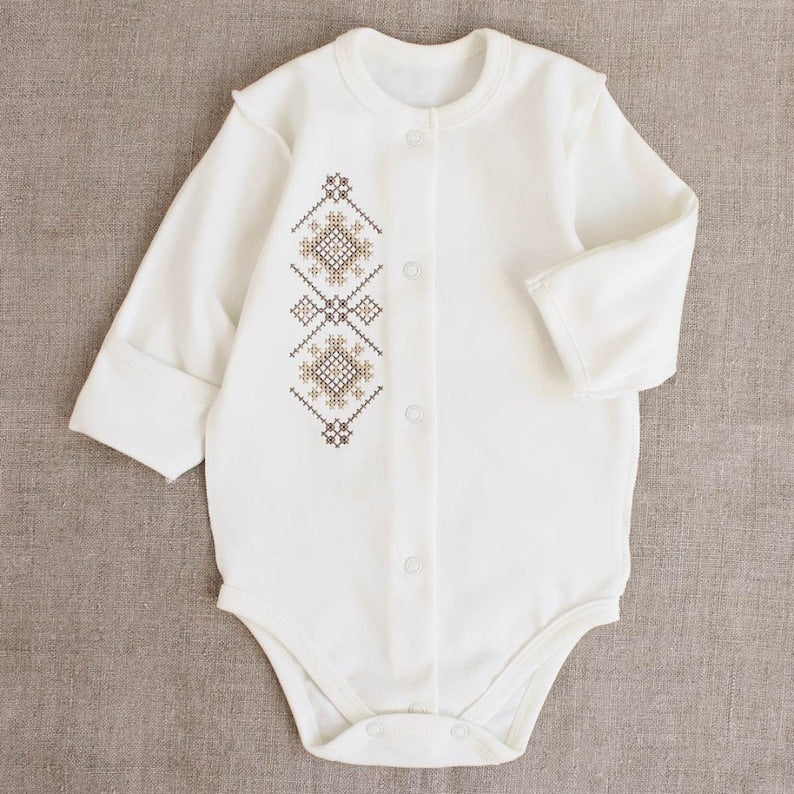 Ukrainian embroidered baby romper with beige-brown patterns, classic Vyshyvanka style, ideal newborn coming-home outfit or baby shower gift.