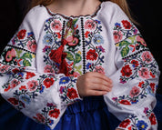 Ukrainian embroidered floral blouse for girls, traditional Vyshyvanka with vibrant cross-stitch design.