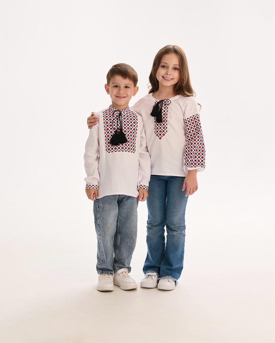 Boy and girl wearing traditional Ukrainian embroidered blouses in Vyshyvanka style, showcasing cultural heritage and ethnic motifs.