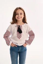 Young girl wearing Ukrainian embroidered blouse with traditional Vyshyvanka patterns, showcasing Slavic folk art style.