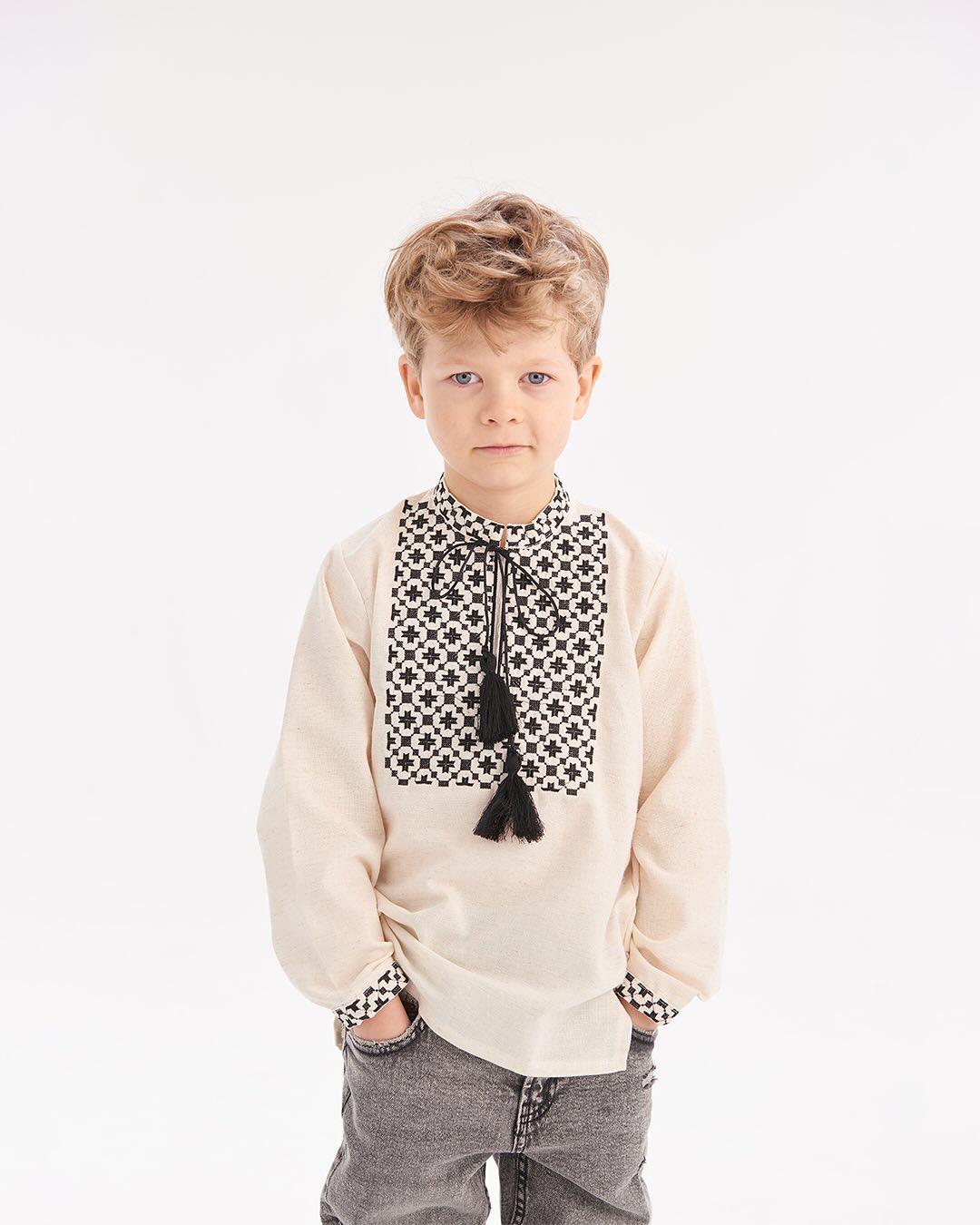 Boy wearing Ukrainian embroidered shirt in Slavic folk style with black and white pattern, suitable for heritage celebrations.