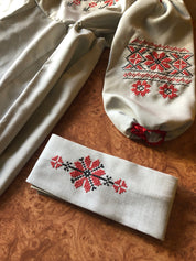 Ukrainian embroidered linen dress with red floral motif and belt, traditional Vyshyvanka style for girls, showcasing cultural elegance.