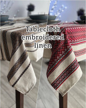 Ukrainian embroidered linen tablecloth with ethnic patterns on dining table, made from 100% natural fabric.