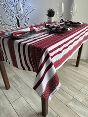 Ukrainian embroidered linen tablecloth on dining table, ethnic rectangle decor, 100% natural fabric, adds cultural charm.