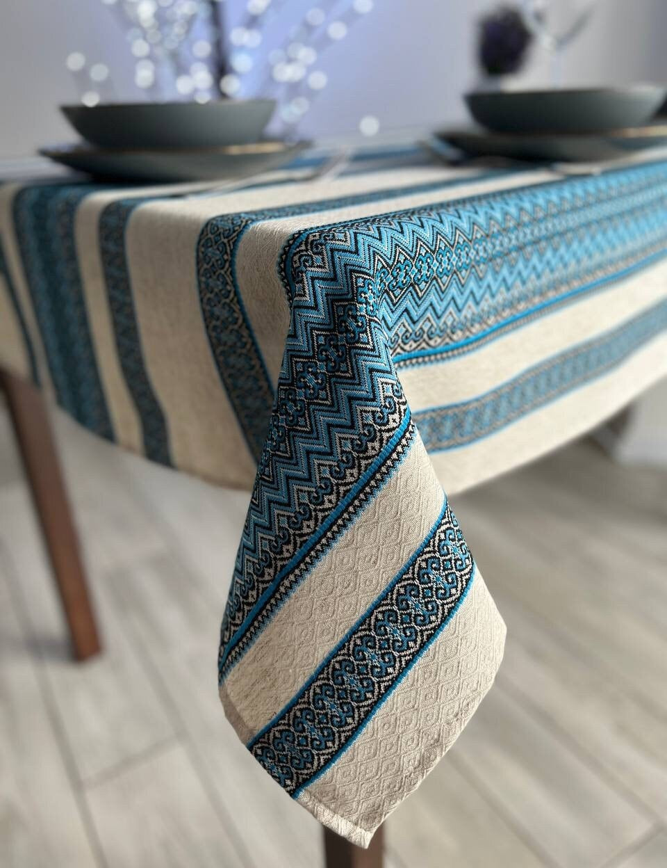 Ukrainian embroidered linen tablecloth with ethnic patterns on a dining table, 100% natural fabric, enhancing home decor.