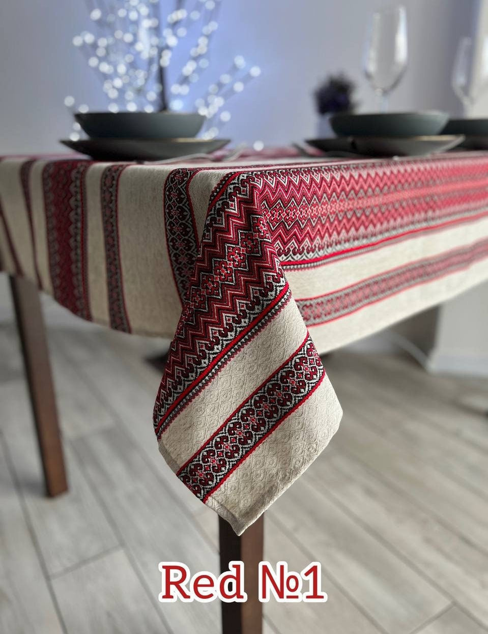 Ukrainian embroidered linen tablecloth with red ethnic patterns, enhancing dining table decor with natural fabric elegance.