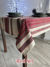 Ukrainian embroidered linen tablecloth with red ethnic patterns, enhancing dining table decor with natural fabric elegance.