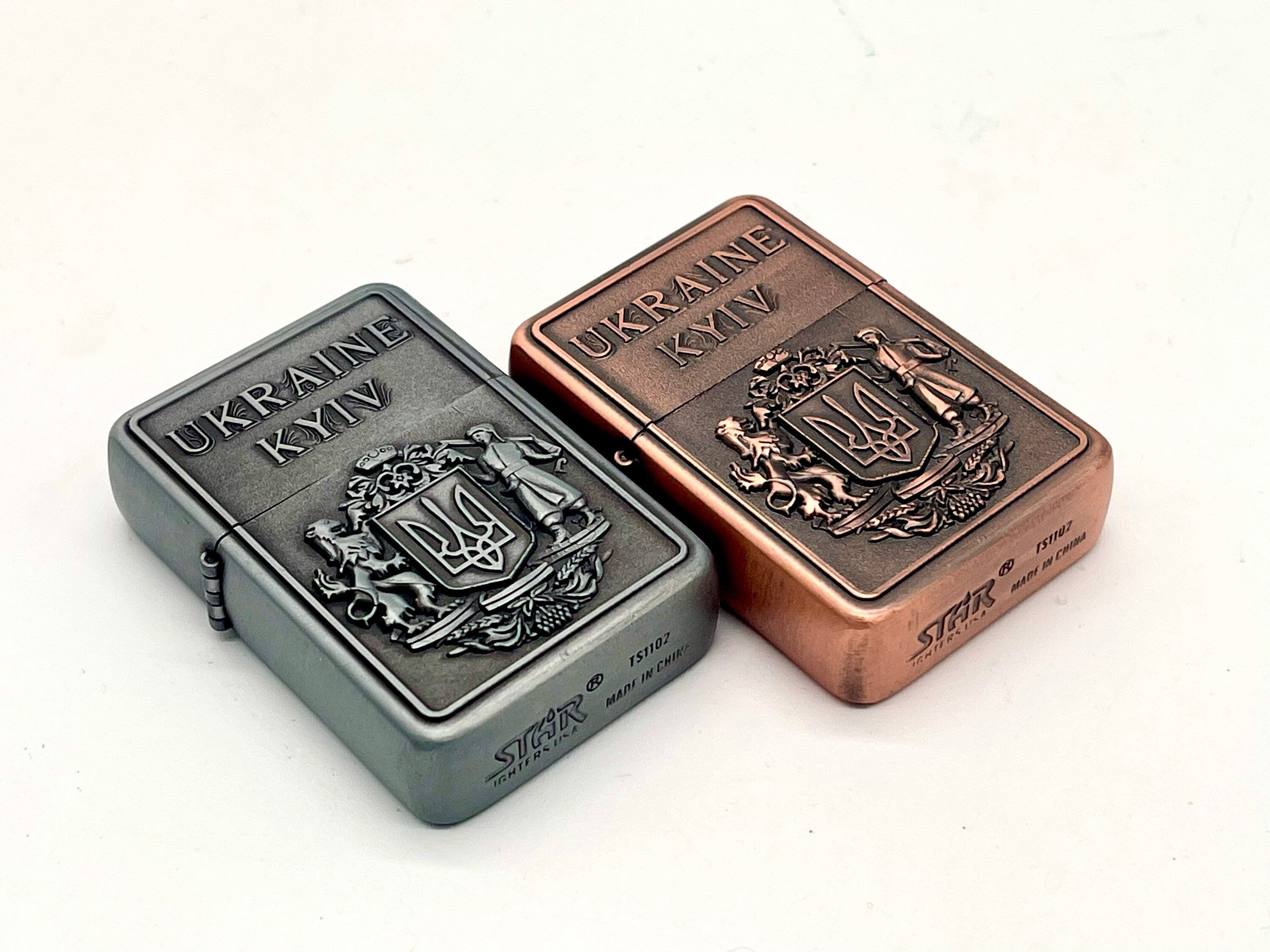Ukrainian gasoline lighters with bronze and silver Coat of Arms, Kyiv design, collectible patriotic symbols.