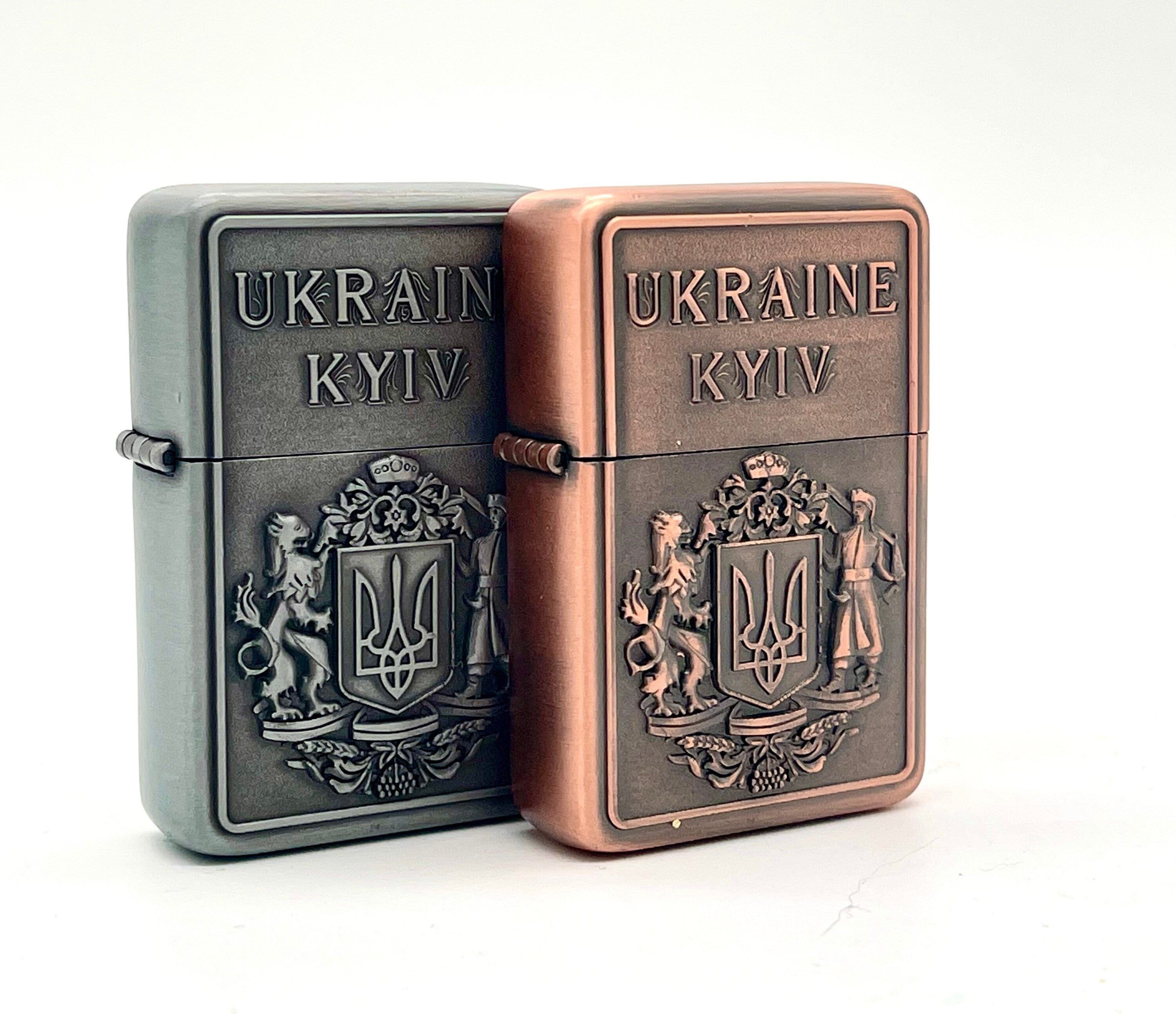 Ukrainian gasoline lighters with bronze and silver coat of arms, showcasing national symbol and collectible design.