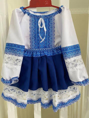 Traditional Ukrainian girl's embroidered blouse and skirt in blue and yellow with lace details, perfect for cultural occasions.
