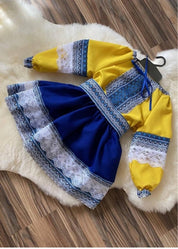 Ukrainian girl embroidered dress set, featuring a blue and yellow blouse and skirt with traditional patterns and lace detail.