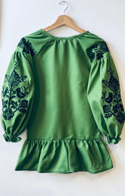 Green Ukrainian embroidered dress with floral sleeve designs, traditional Vyshyvanka style.