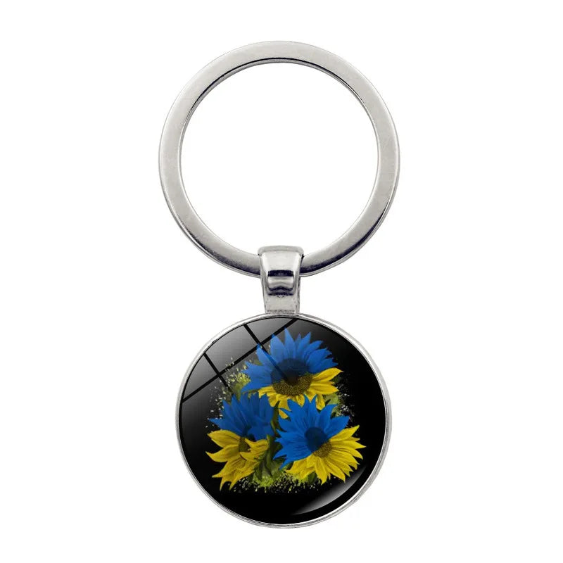 Ukrainian glass keychain with blue and yellow sunflower emblem, showcasing cultural pride and craftsmanship.