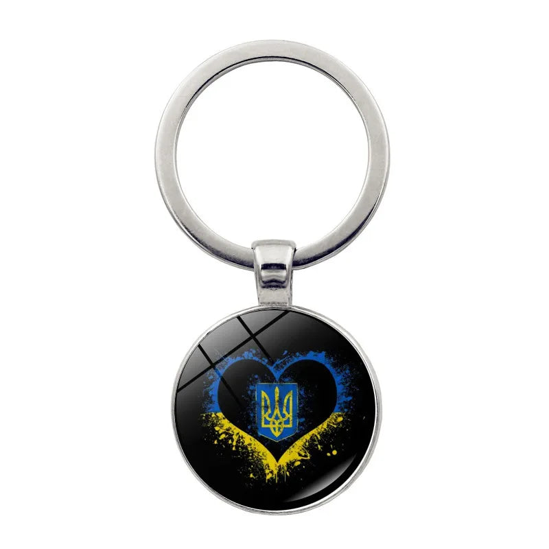 Ukrainian glass keychain with heart and emblem design, showcasing national pride and cultural heritage.