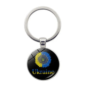 Ukrainian glass keychain with emblem, featuring a colorful design representing Ukrainian heritage and pride.