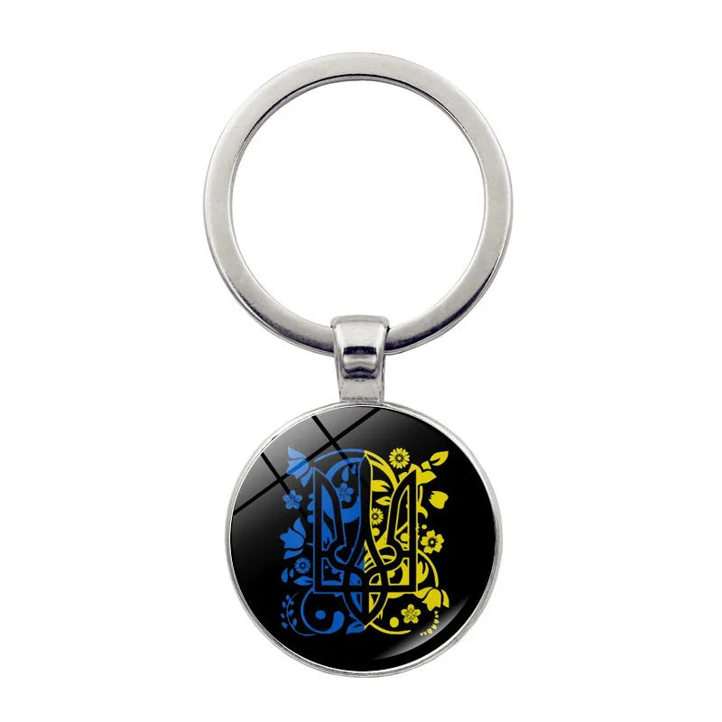 Ukrainian glass keychain with blue and yellow emblem, showcasing pride in Ukrainian heritage and culture.